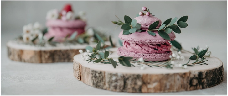 aesthetische lila macarons mit frischen blaettern und blumen