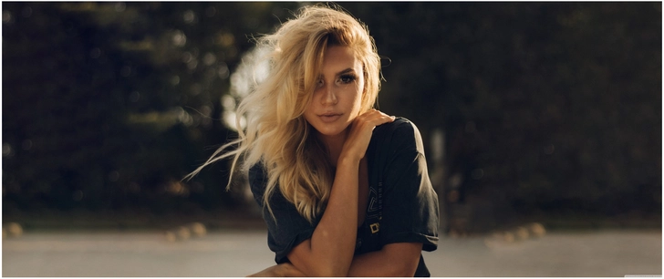 junge frau mit blonden haaren in entspannter pose