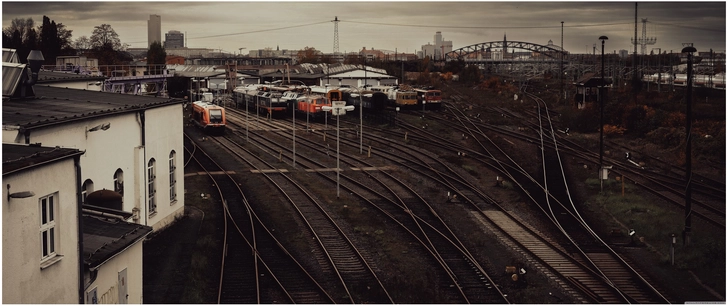 urbaner bahnhof bereich mit eisenbahnschienen und zuegen