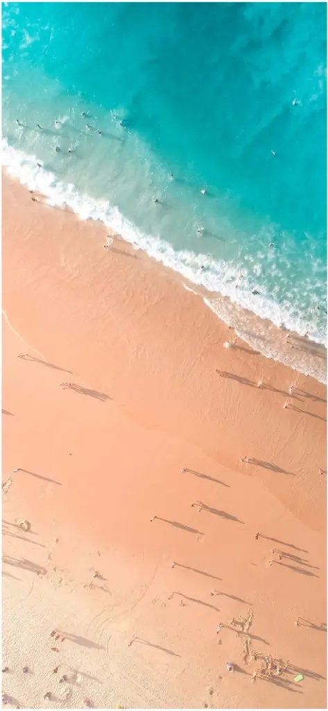 vogelperspektive auf einen sonnigen strand mit menschen