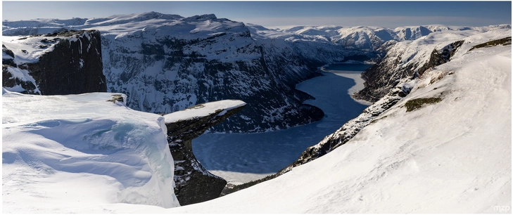 winterlandschaft mit fjord und felsvorsprung in norwegen